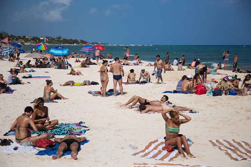 Visitors enjoy the beach in Playa del Carmen.