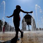 A youngster enjoys the fountains at the Monument to the Revolution in Mexico City.