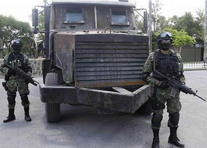 Security forces stand guard over an 'artisanal' truck in Tamaulipas.