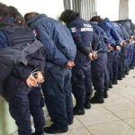 Ocampo's police force after their arrest yesterday.