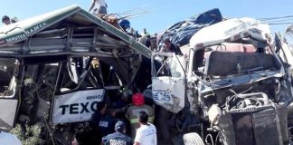 The wreckage of a bus and truck in the accident that killed 11 yesterday.