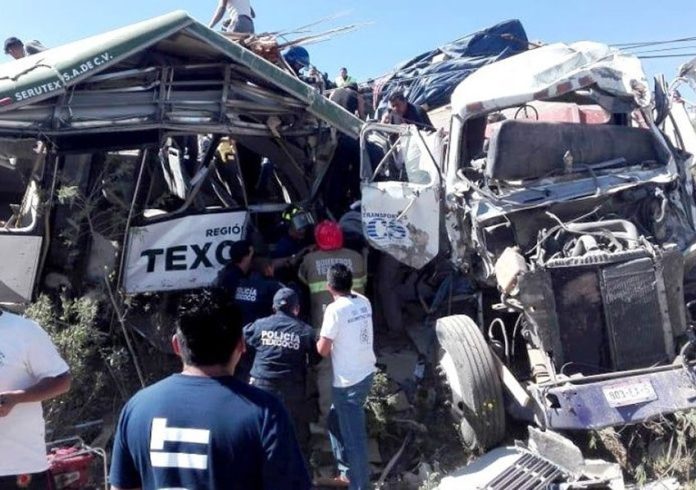 The wreckage of a bus and truck in the accident that killed 11 yesterday.