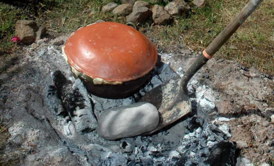 Tamales and mushrooms cooking in hot coals.
