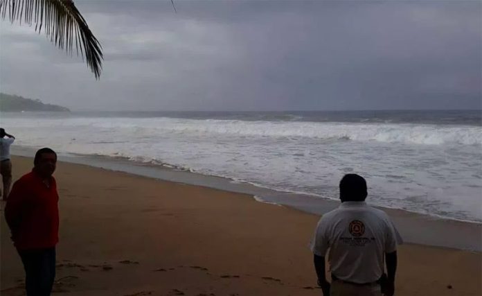 A lifeguard patrols a beach in Acapulco.