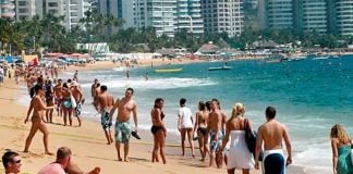Tourists on an Acapulco beach: their numbers continue to rise.