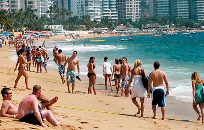 Tourists on an Acapulco beach: their numbers continue to rise.