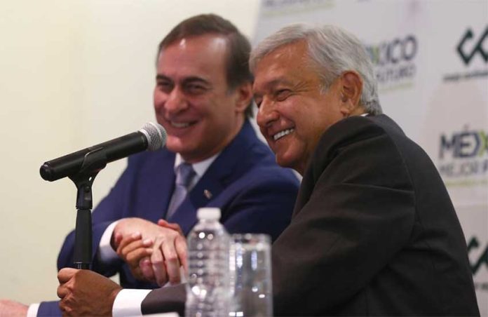 Castañon, left, and López Obrador shake on new agreement.
