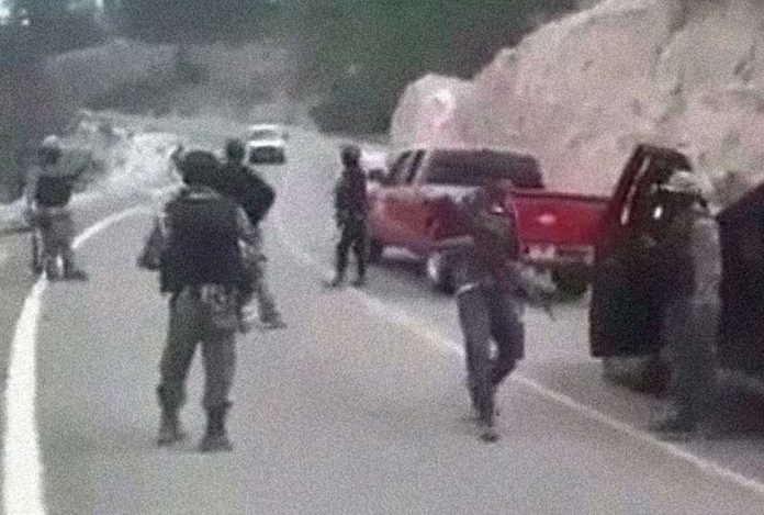 What appears to be a cartel convoy lined up on a highway in Mexico.