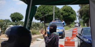 A self-defense force guard mans a Morelos checkpoint.