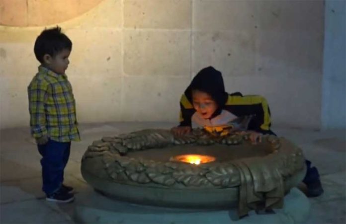 Happy birthday: a boy blows out the eternal flame in Guanajuato.