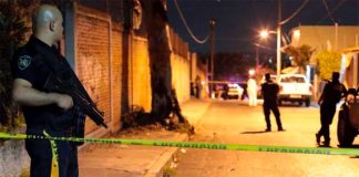 Police at the scene of the funeral vigil.
