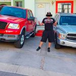 The alleged suspect with two of his luxury vehicles.