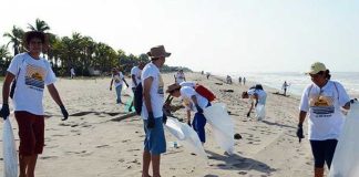 Volunteers clean up litter from a beach in Manzanillo, Colima.
