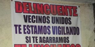 Signs such as this have appeared in several communities to warn criminals they will be lynched if caught.