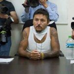 Former gangster 'El Mijis,' center, at a press conference.
