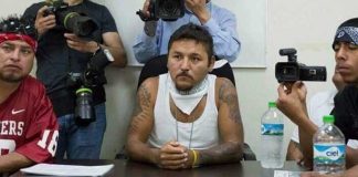 Former gangster 'El Mijis,' center, at a press conference.