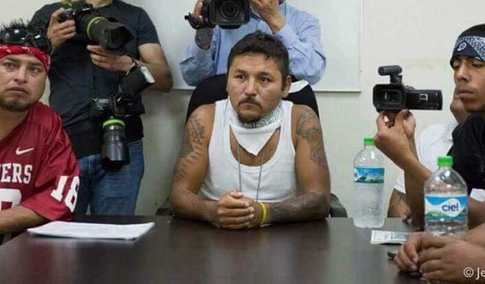 Former gangster 'El Mijis,' center, at a press conference.
