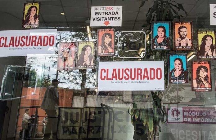 Posters placed on the window at the Mexico City Attorney General's office in protest against inaction on the homicide investigation.