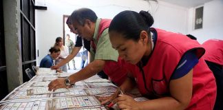 Election workers with ballots in Puebla.