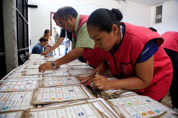 Election workers with ballots in Puebla.