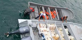 The smugglers' boat, foreground, with its cargo of cocaine and fuel.