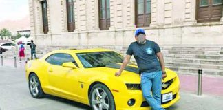 The suspect and one of his luxury vehicles.