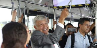 AMLO rides a Mexico City airport transport vehicle to catch a commercial flight to Juárez. He has vowed to fly commercial as president.