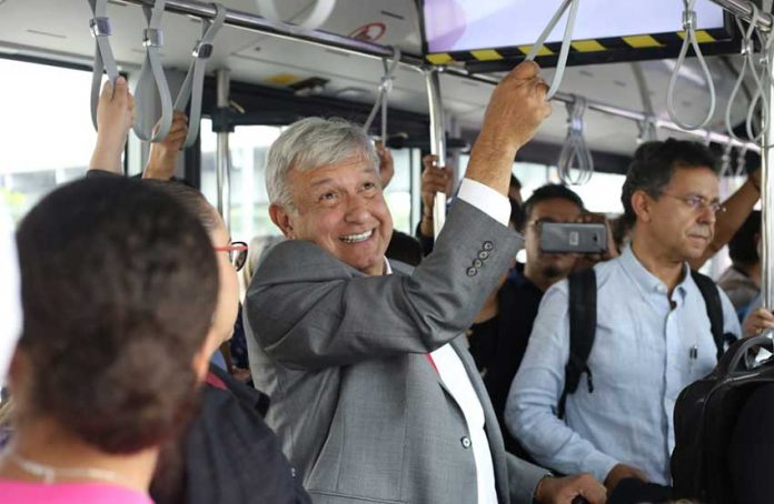 AMLO rides a Mexico City airport transport vehicle to catch a commercial flight to Juárez. He has vowed to fly commercial as president.