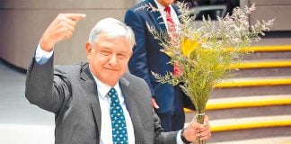 López Obrador greets supporters, who presented him with a bouquet of flowers, after yesterday's ceremony.