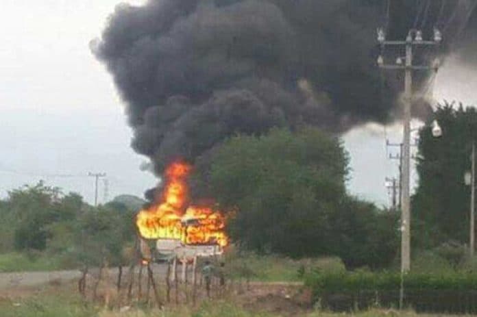 A vehicle burns at a Michoacán blockade.