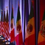 The national flags of Canada, the U.S. and Mexico are lit by stage lights before a news conference at the start of NAFTA renegotiations in Washington