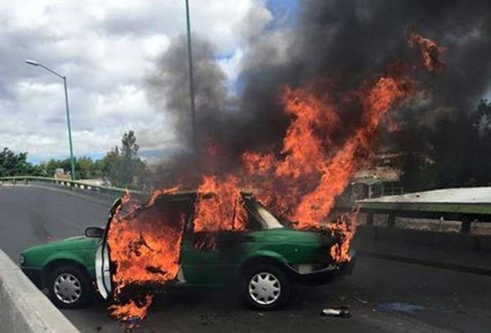 A taxi burns during cartel violence in Jalisco in 2015.