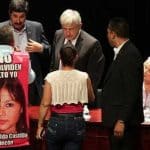 José Luis Castillo at yesterday's forum wearing his canvas sign that bears a photo of his missing daughter.