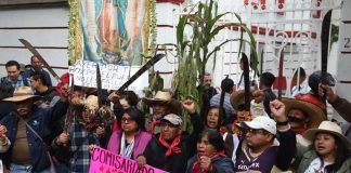 Airport protesters raise their machetes in defiance against the project.
