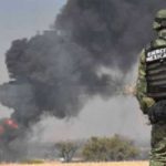 A soldier watches as a fire burns at a tap on the Tula-Salamanca pipeline in Guanajuato.