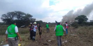 Rescue workers help passengers after yesterday's plane crash.