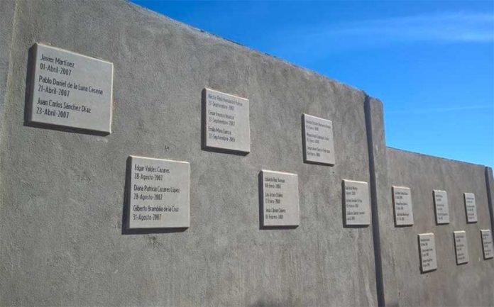 The memorial wall where hundreds of bodies were disposed of.