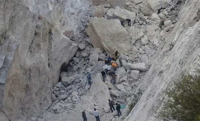 Rescue workers at the site of today's rockslide in Hidalgo.