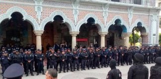 State police watch over disarmed Tehuacán police this morning.