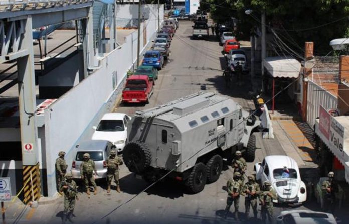 A military vehicle blocks the street outside Acapulco police headquarters.
