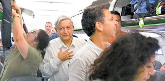 AMLO aboard his commercial flight from Huatulco to Mexico City last night.