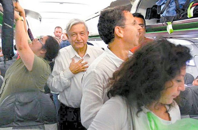 AMLO aboard his commercial flight from Huatulco to Mexico City last night.