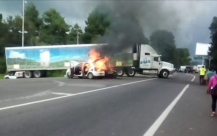 A car burns at a blockade on Wednesday.