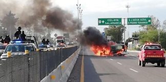 A vehicle burns yesterday in Guanajuato, set on fire by fleeing gangsters.