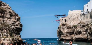 A diver leaves one of the two platforms in Polignano a Mare.