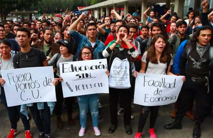 UNAM students protest Monday's aggression.