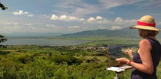 The artist painting at a spot overlooking Guachimontones archaeological ruins.