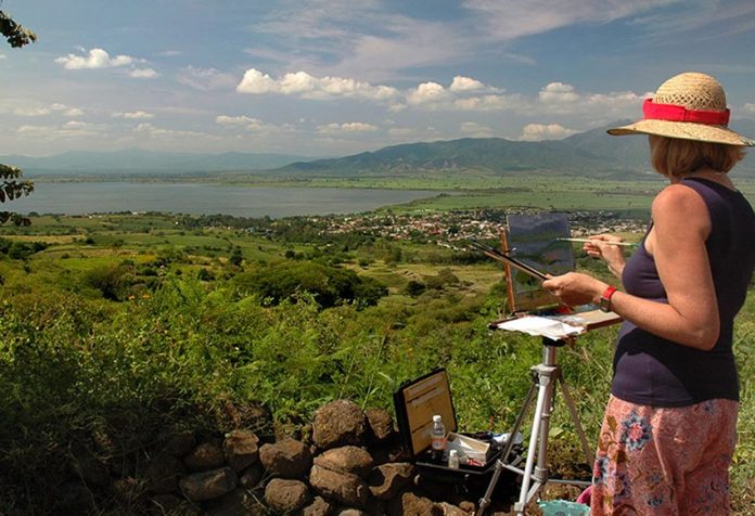 The artist painting at a spot overlooking Guachimontones archaeological ruins.