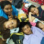 A family poses in their makeshift beds for the night in Arriaga.