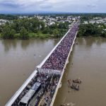 Migrants on the bridge at the Guatemala border yesterday.